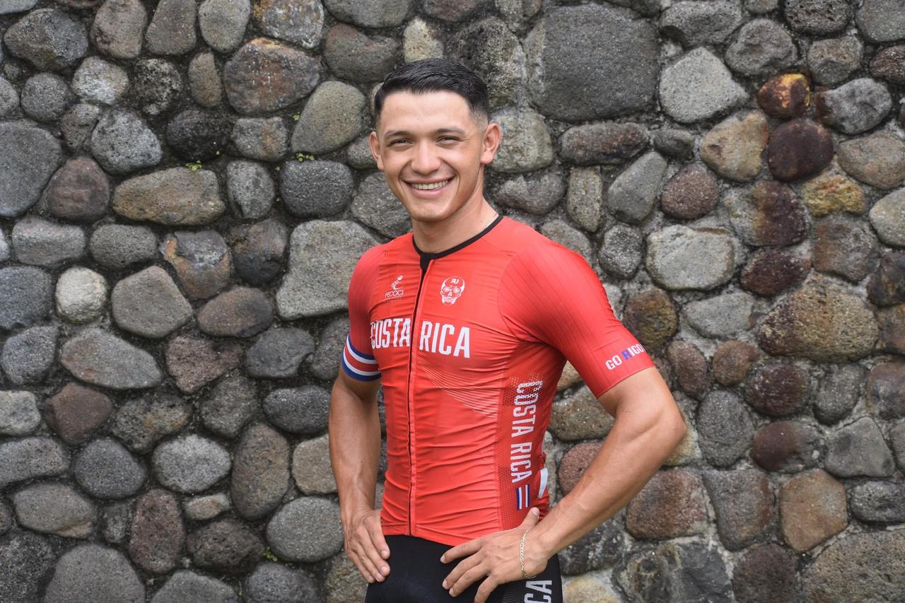 Costa Rican cyclist smiling, wearing red jersey.
