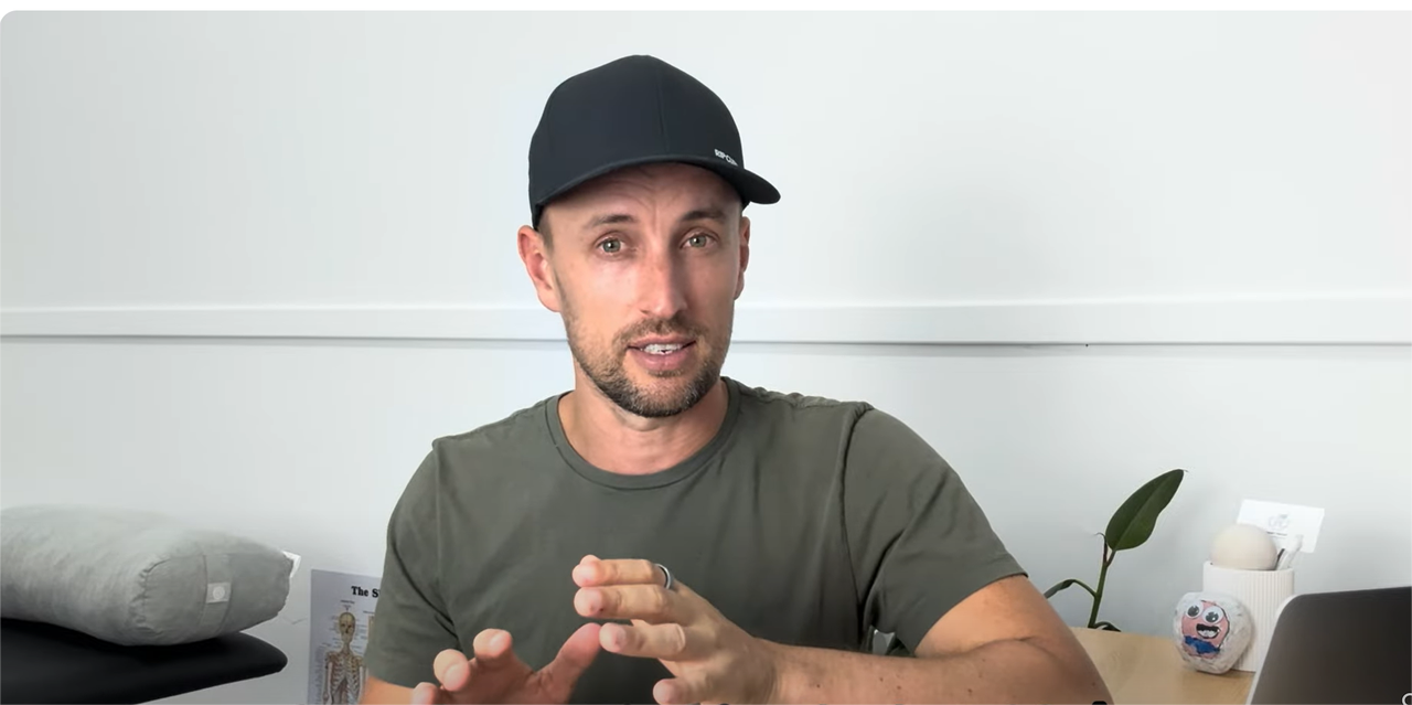 Man wearing smart ring speaking about health tracking on a white background