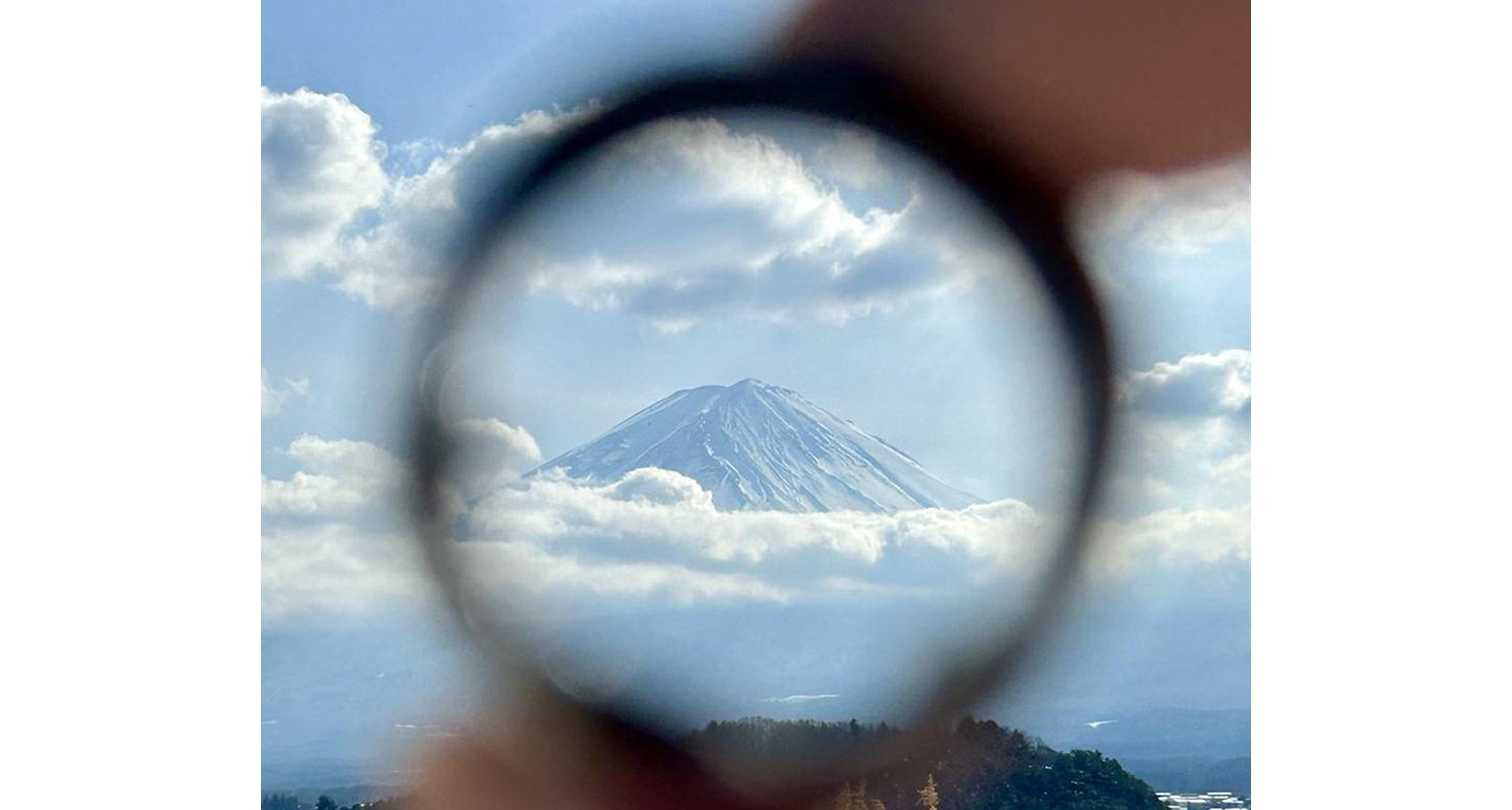 Smart ring framing a snow-capped mountain view, with the focus on the mountain.