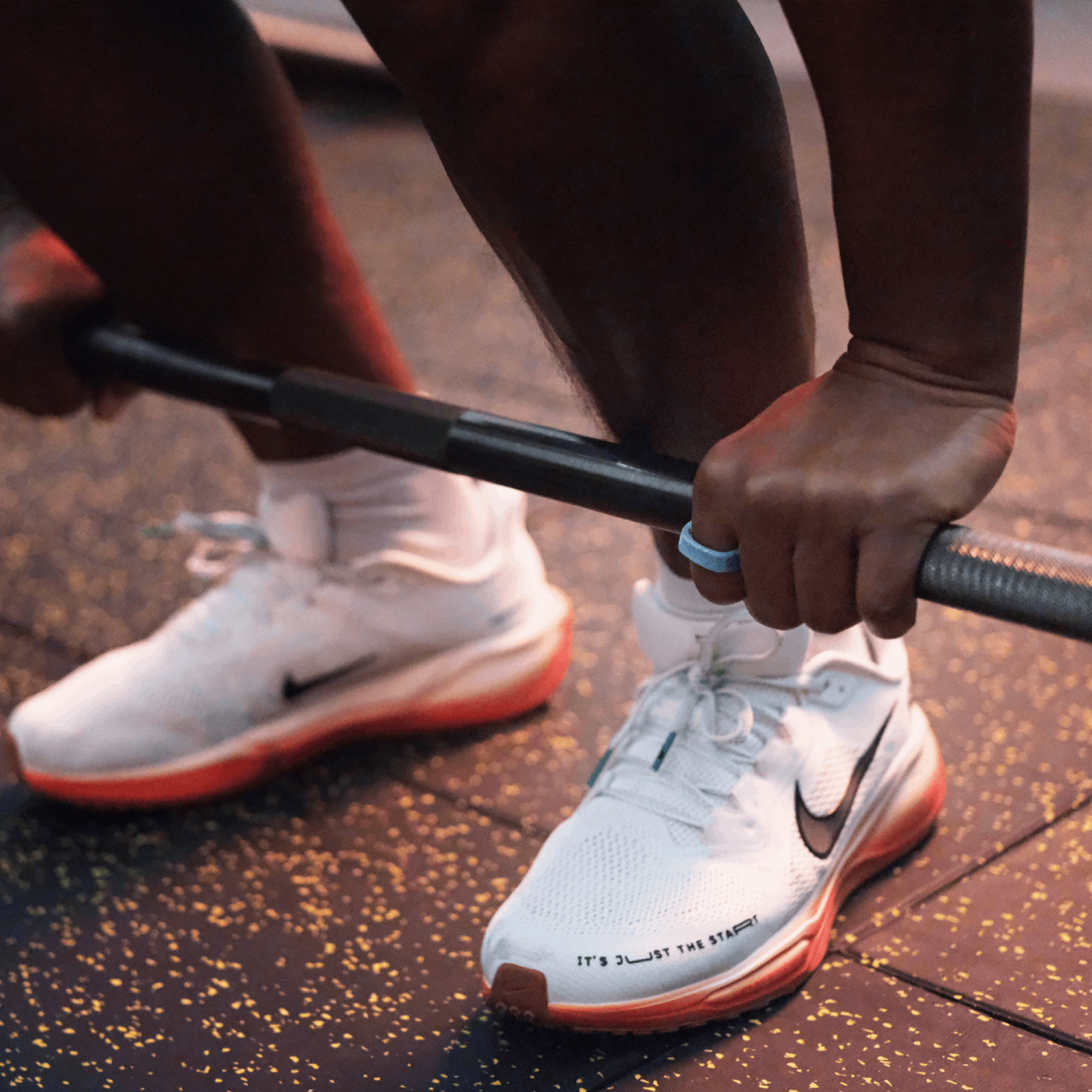 Blue medical silicone ring protector on hand lifting barbell, fitness ring for activity and sleep tracking.