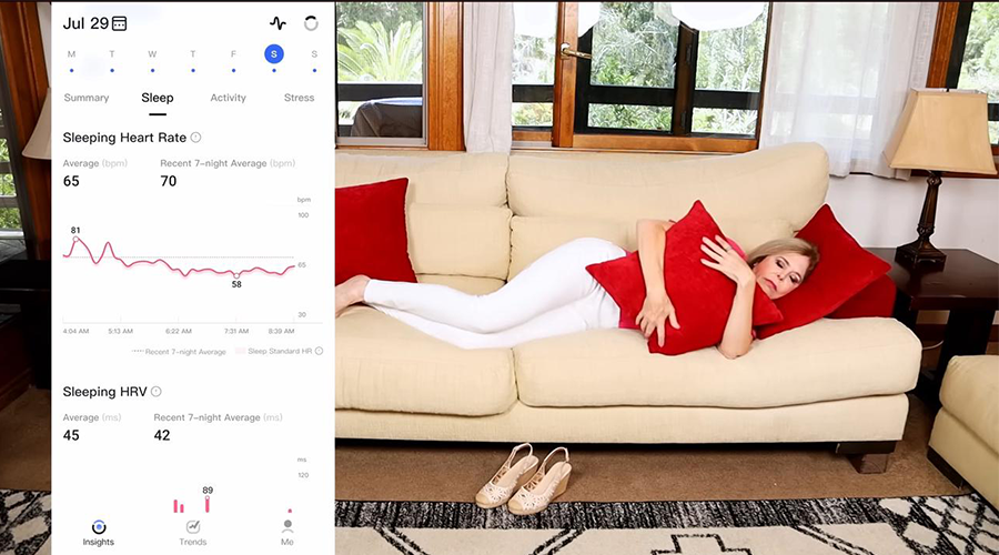 Woman resting on a couch with health data display, monitoring sleep heart rate and HRV.