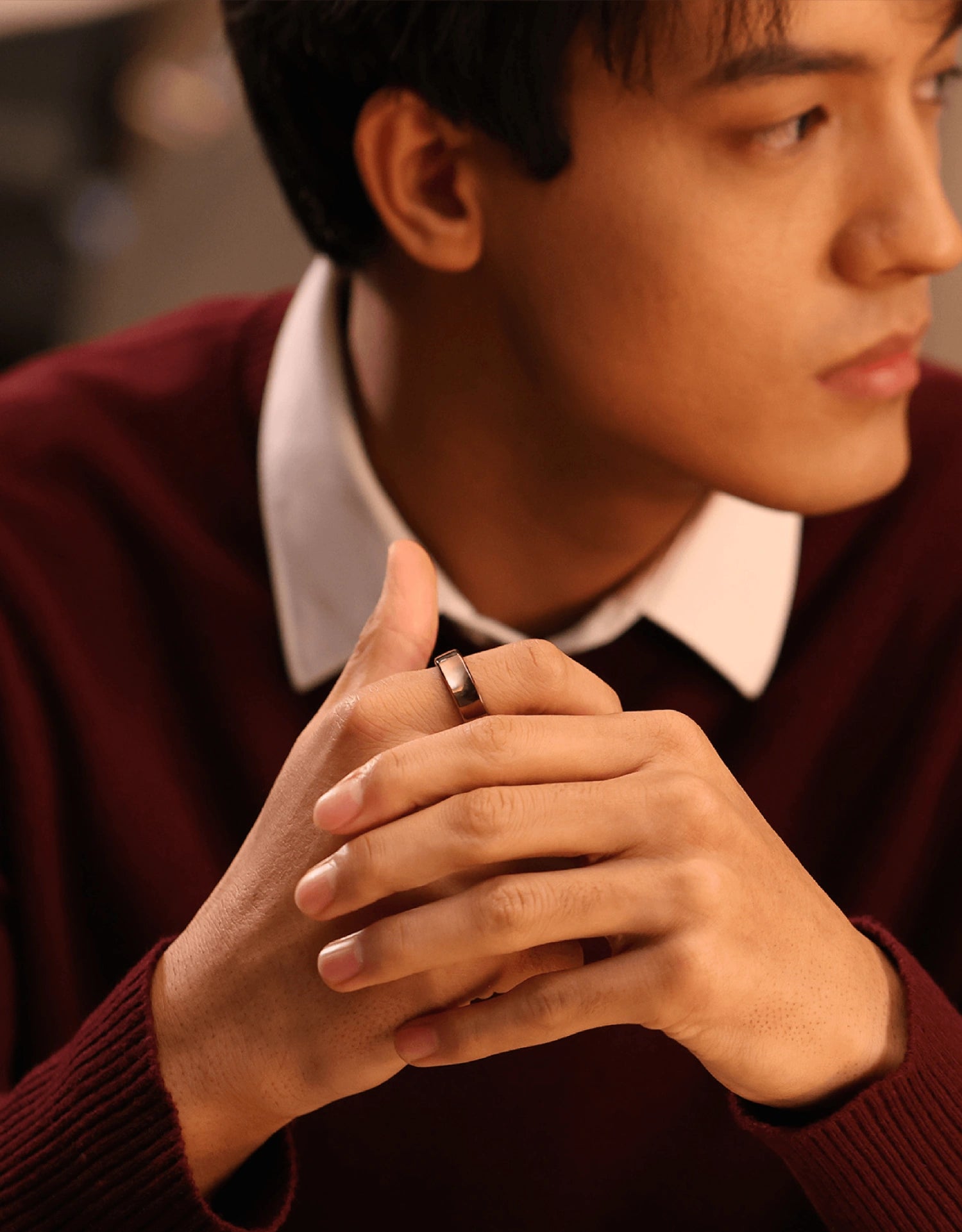 Man wearing a dark smart ring, showcasing sleek design and material.