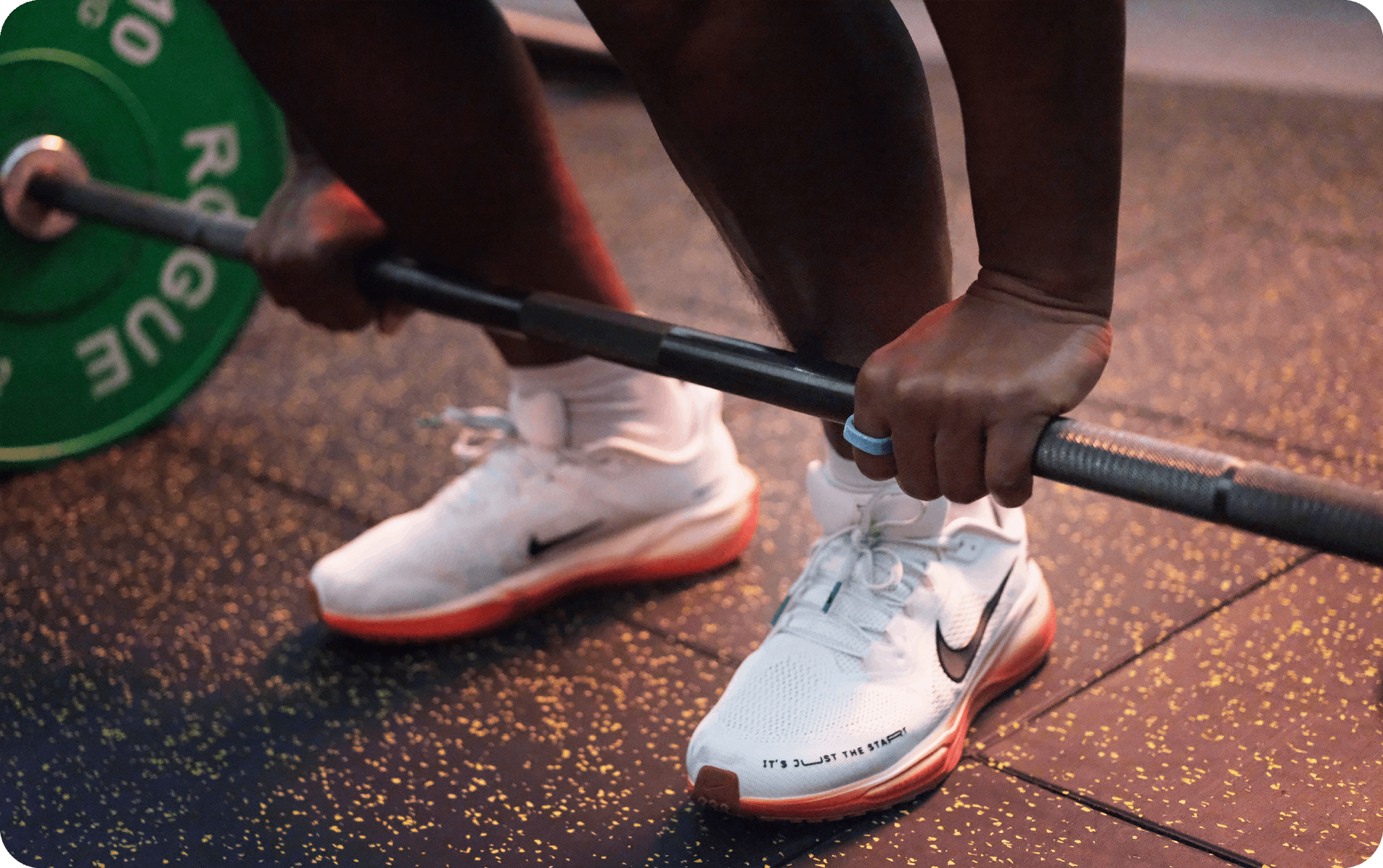 Athlete lifting barbell with a blue smart ring, emphasizing fitness tracking technology.